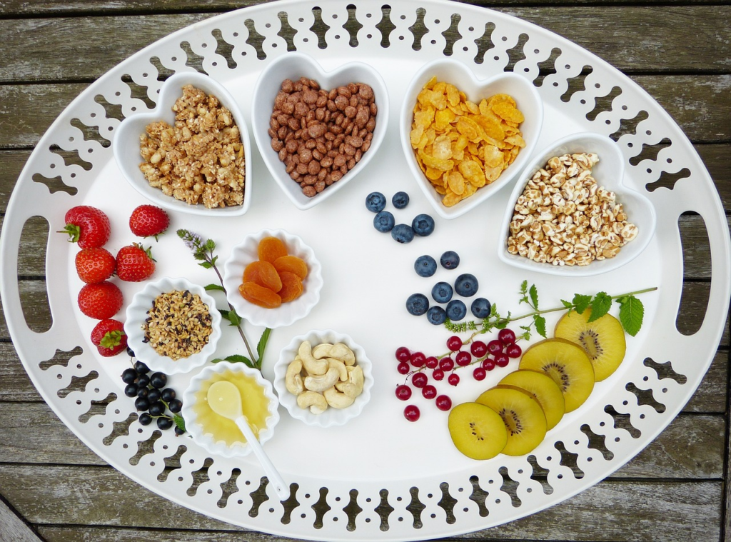 An image showcasing a vibrant dinner table filled with colorful plant-based dishes, including a variety of fruits, vegetables, whole grains, and legumes, reflecting James Duncan's notable vegetarian diet